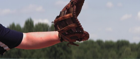 Super slow motion shot of Caucasian teenager baseball player catching a ball outside. Shot with high speed video camera at 420 FPS