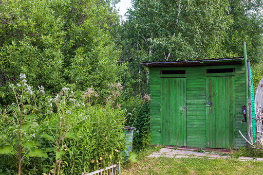 Green Country toilet in the open air. Wooden structure for outdoor toilet. Cabin - Toilet in the woods in nature.