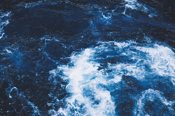 Fototapeta na wymiar Dark blue texture of the sea with waves