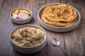 cream chicken curry with flatbread chapati or parantha