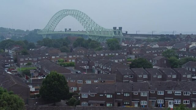British Northern Runcorn bridge suburban residential townhouse neighbourhood aerial view left dolly