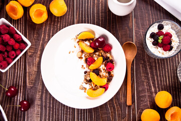 cottage cheese and yougurt with granola, berries and fruits apricot for healthy breakfast.