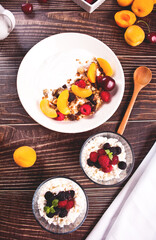 cottage cheese and yougurt with granola, berries and fruits apricot for healthy breakfast.