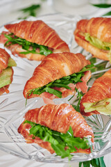 Mini croissants with filling on the festive table. Buffet, catering. High quality photo
