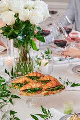 Mini croissants with filling on the festive table. Buffet, catering. High quality photo
