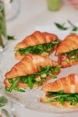 Mini croissants with filling on the festive table. Buffet, catering. High quality photo