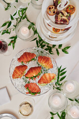 Mini croissants with filling on the festive table. Buffet, catering. High quality photo