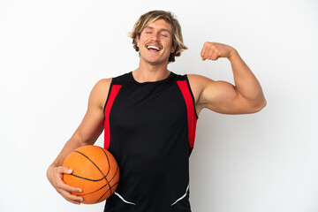 Young blonde man holding a ball of basketball isolated on white background doing strong gesture