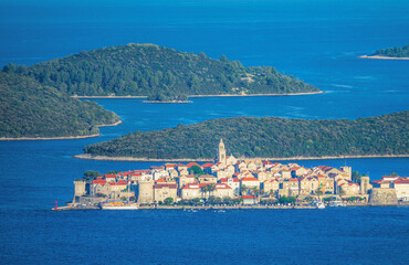 AERIAL: Tranquil old town of Korcula is surrounded by the tranquil Adriatic sea.