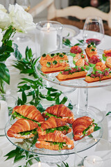 Mini croissants with filling on the festive table. Buffet, catering. High quality photo