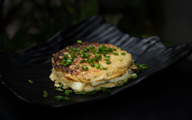 Herb cheese omelette with chives and green onion and oregano sprinkled with Herb omelette with chili flakes