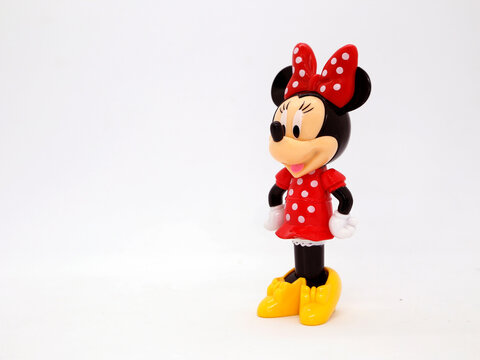 Minnie Mouse in her classic red polka dot dress. Toy. Cartoon character from Walt Disney Pictures Studios. Minnie is Mickey Mouse's girlfriend. Plastic doll. Daisy duck's friend. Isolated white.