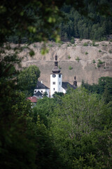 Tower of Spania Dolina church surrounded by trees, Slovakia - obrazy, fototapety, plakaty