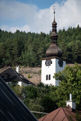 Tower of Spania Dolina church surrounded by trees, Slovakia - obrazy, fototapety, plakaty