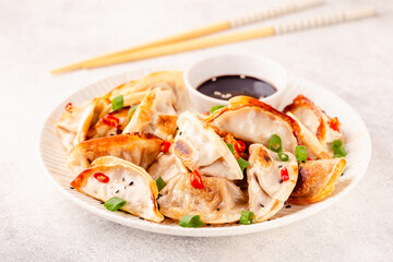 Fried dumplings served with green onions.