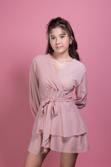 Portrait beautiful young woman in the studio on pink background
