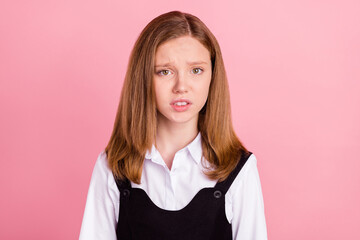 Photo of impressed shocked school girl wear white black uniform listening bad news isolated pink...