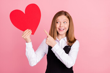 Photo of shocked cute school girl wear white black uniform smiling pointing looking big red heart...