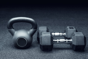 A sports kettlebell and two dumbbells for professional workouts in the gym