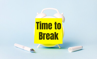 On a light blue background - a white handle and an alarm clock with a bright yellow sticker glued to it with the text TIME TO BREAK