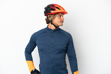 Young blonde cyclist man isolated on white background looking to the side - obrazy, fototapety, plakaty