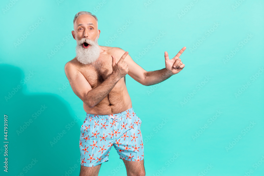 Sticker Portrait of elderly pensioner retired amazed bearded man showing copy space isolated over bright teal turquoise color background