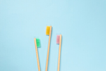 Bamboo toothbrush on a blue background.