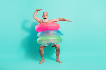 Full length body size view of attractive cheerful bearded man wearing rubber rings dancing isolated over bright teal turquoise color background - Powered by Adobe