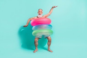 Photo of impressed cool retired man naked torso dancing inside swimming circles isolated turquoise...