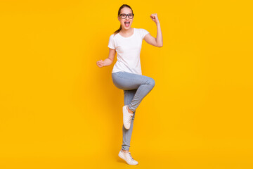 Full length photo of young excited woman happy positive smile rejoice victory success isolated over yellow color background