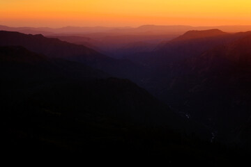 Fototapeta premium Layers of Mountain Ranges in Golden Sunset Light Valleys