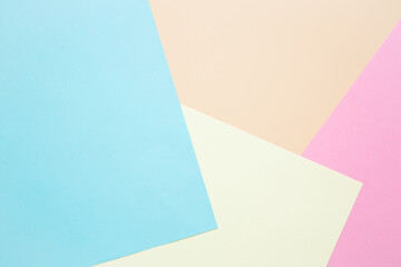 Sheets of colored paper as a background: blue, pink and yellow. Layout, copy space. Geometric print.
