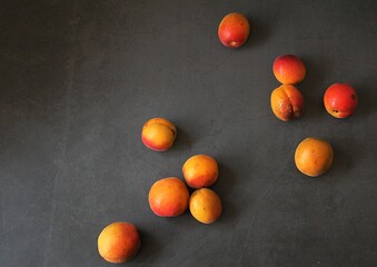 fresh apricots, orange fruits, summer vitamins, small apricots on a dark background