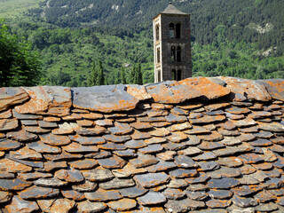 Traditional slate roof and view of the bell tower of the church of Sant Climent in the village of...