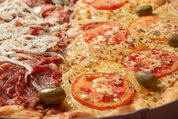 Pizza, detail of a pizza in Brazil with two flavors of mozzarella and pepperoni, selective focus
