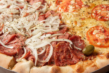 Pizza, detail of a pizza in Brazil with two flavors of mozzarella and pepperoni, selective focus