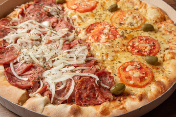 Pizza, pizza delivery inside the cardboard box used for delivery on a table, selective focus