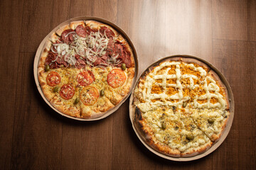 Pizza, two pizzas in Brazil inside cardboard boxes as they are delivered on a table, top view