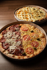Pizza, two pizzas in Brazil inside cardboard boxes as they are delivered on a table, selective focus