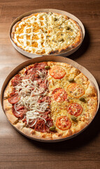 Pizza, two pizzas in Brazil inside cardboard boxes as they are delivered on a table, selective focus