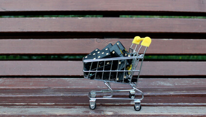 Small shopping cart full of black domino dice