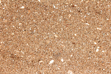 Abstract background of golden sand with small pebbles