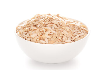 Close-up of white dry muskmelon (Cucumis melo) seed  in a white ceramic bowl over white background.