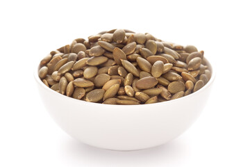 Close-up Organic roasted green pumpkin seed (Cucurbita pepo) in white bowl isolated on white background