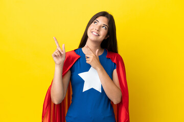 Super Hero Brazilian woman isolated on yellow background pointing with the index finger a great idea © luismolinero