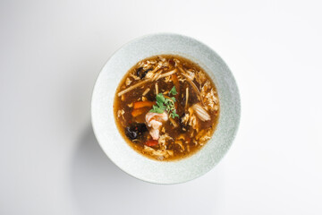 asian sour spicy seafood Soup with Shrimps and Fresh Vegetables isolated on white background