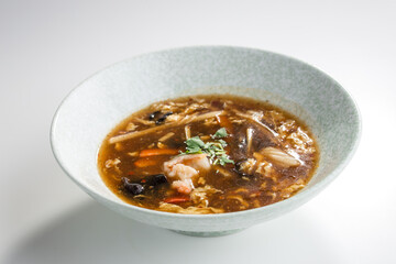 asian sour spicy seafood Soup with Shrimps and Fresh Vegetables isolated on white background