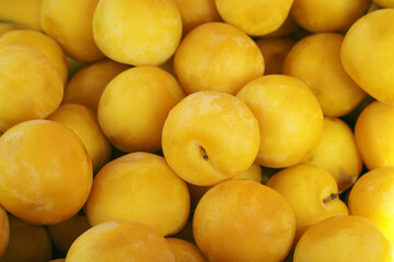 yellow plums on market stall