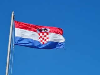 Croatian flag on blue sky. Country flag against sky. Flags of the world - obrazy, fototapety, plakaty