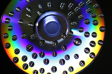 multi-colored and colorful CD on a black background